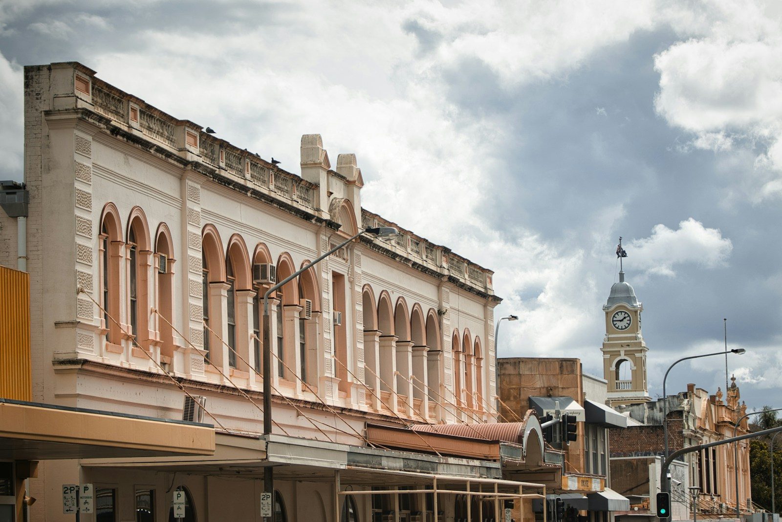 Historic buildings line a street with a clock tower
